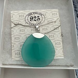 Aqua-toned pendant set in sterling silver. NWT